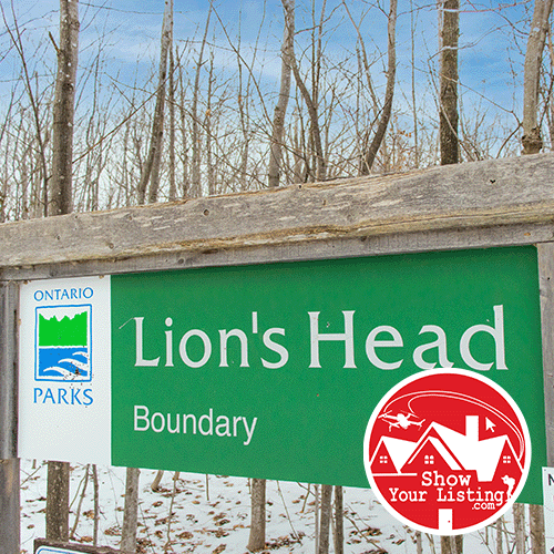 Stunning aerial view of Lions Head on the Bruce Peninsula, showcasing crystal clear waters and hiking trails, perfect for real estate media and showcasing local attractions.